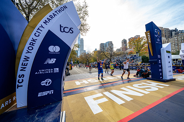 Runners crossing finish line of 2021 TCS NYC Marathon